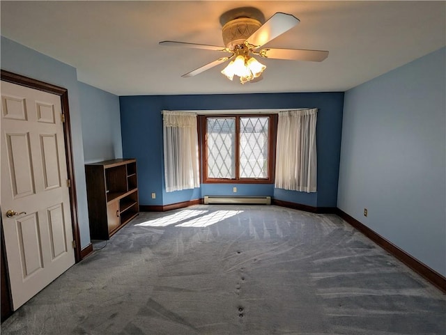 interior space featuring dark colored carpet, a baseboard radiator, and ceiling fan