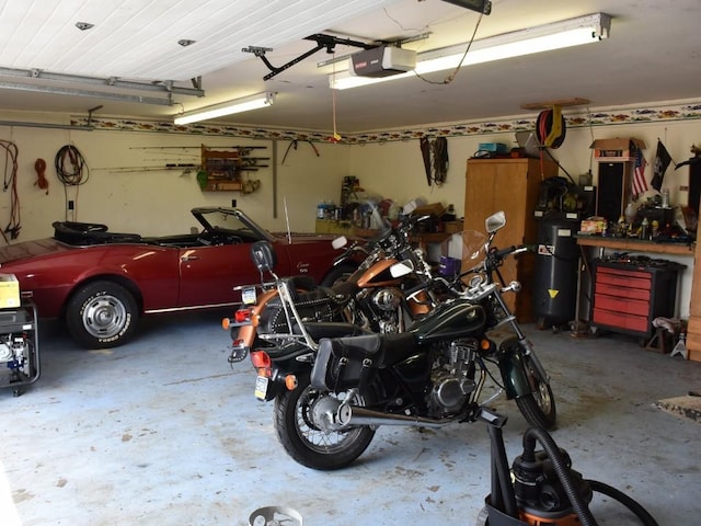 garage with a workshop area and a garage door opener