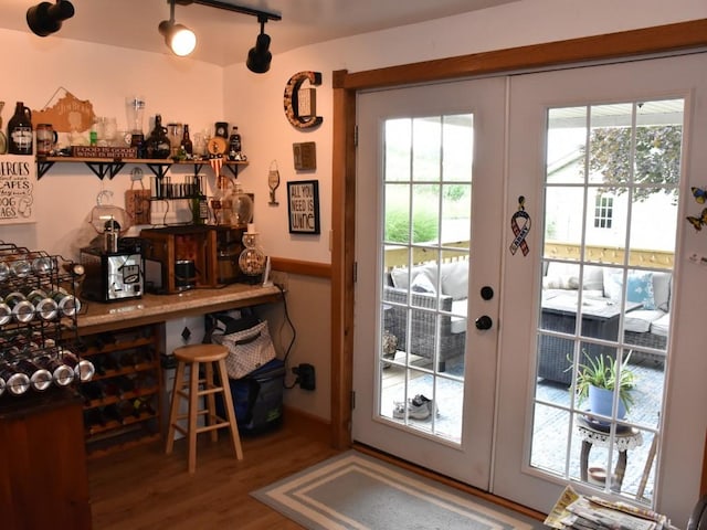 doorway to outside with french doors, hardwood / wood-style floors, and indoor bar