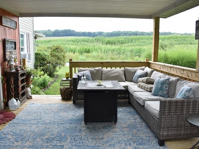 exterior space with a rural view, an outdoor hangout area, and a wooden deck