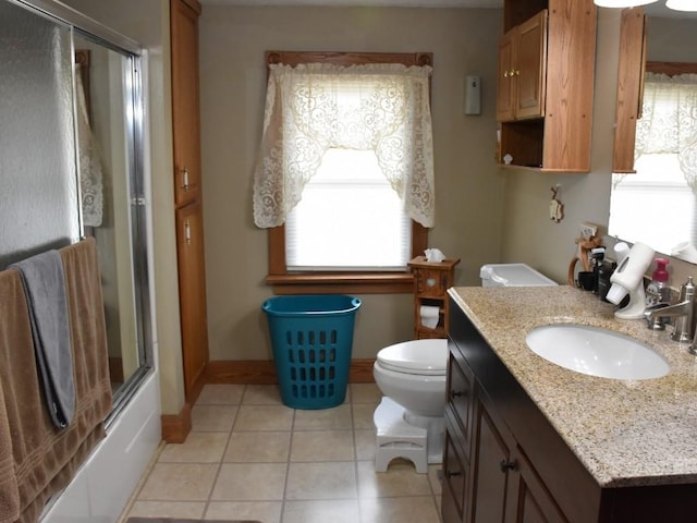 full bathroom featuring tile patterned floors, vanity, bath / shower combo with glass door, and toilet