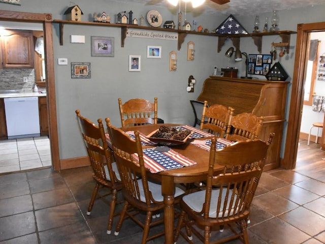 tiled dining area with ceiling fan