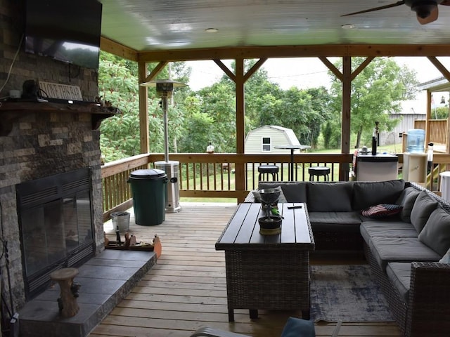 deck with outdoor lounge area and ceiling fan