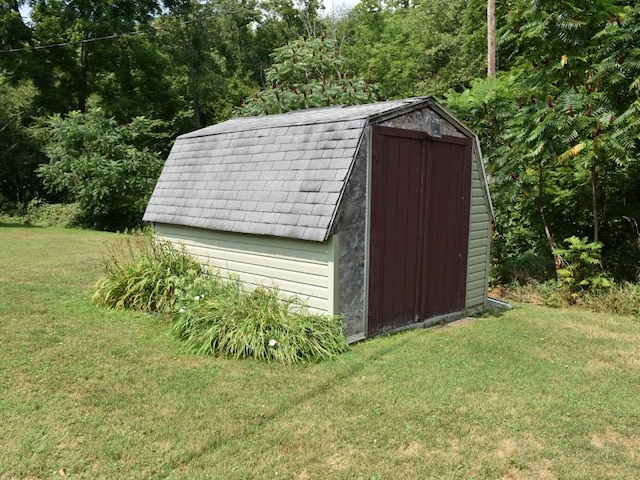 view of outbuilding featuring a yard