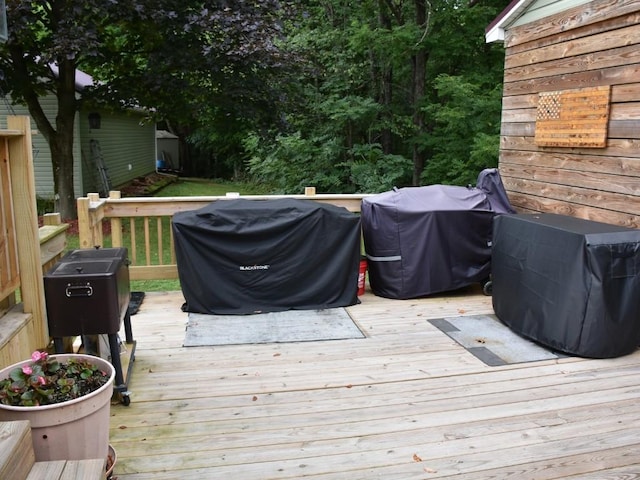 wooden terrace featuring a grill