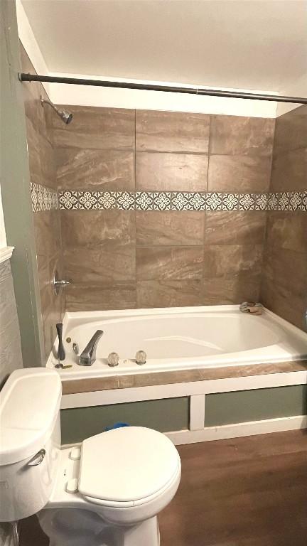 457 E 24th St, Erie, PA 16503 - bathroom with wood finished floors and a combined bath / shower with jetted tub
