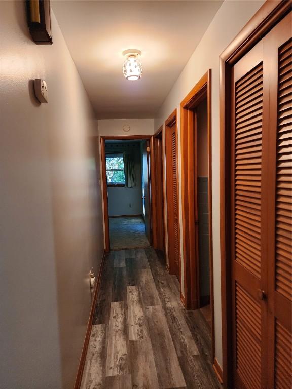 hallway with dark hardwood / wood-style floors