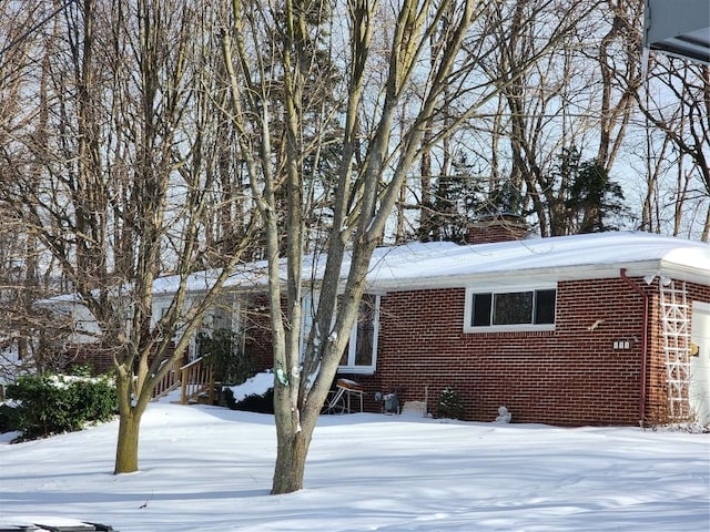 snow covered property featuring a garage