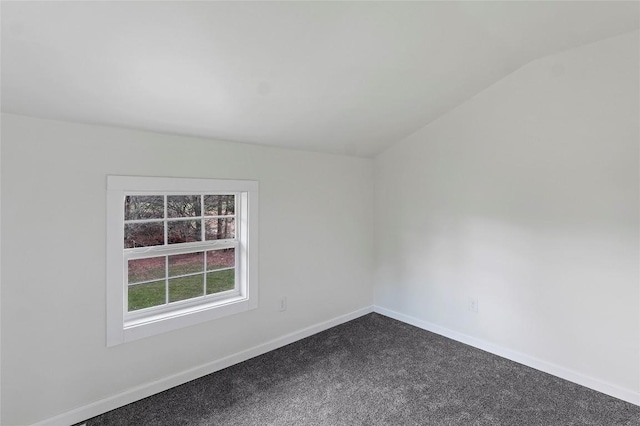 empty room featuring carpet and lofted ceiling