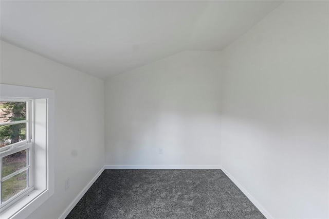 unfurnished room featuring vaulted ceiling and carpet