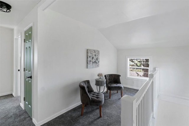 living area featuring dark carpet and lofted ceiling