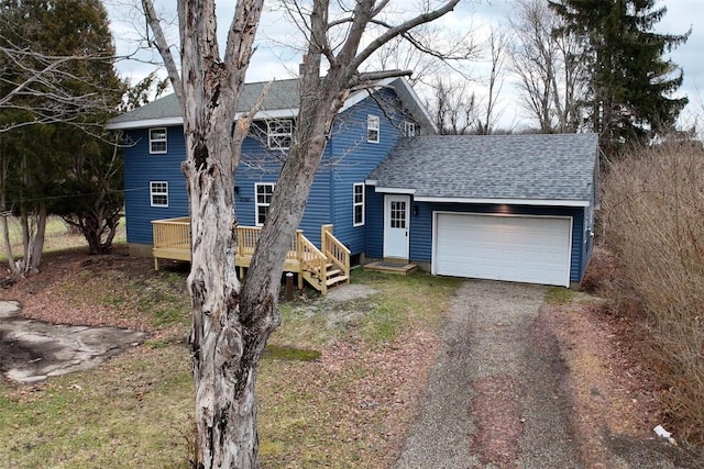 view of front of house featuring a deck and a garage