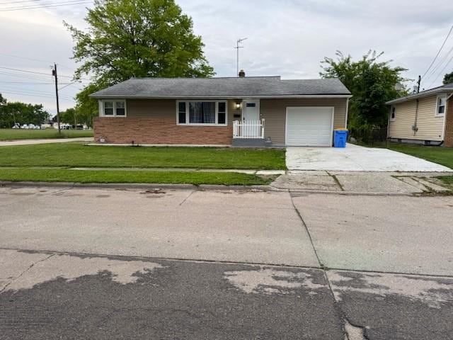 3603 Wallace St, Erie, PA 16504 - ranch-style house featuring concrete driveway, a front lawn, a garage, and brick siding