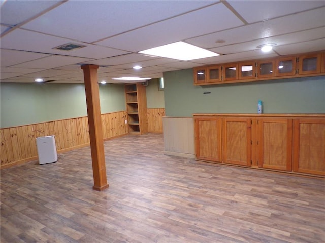 13326 Ridge Rd, West Springfield, PA 16443 - finished basement featuring a wainscoted wall, light wood-style floors, baseboards, wooden walls, and a drop ceiling
