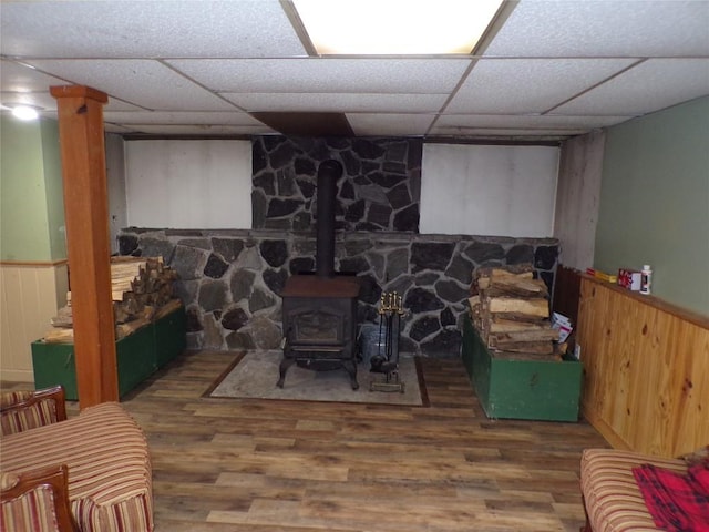 13326 Ridge Rd, West Springfield, PA 16443 - living area featuring wood finished floors, a drop ceiling, a wood stove, and wainscoting