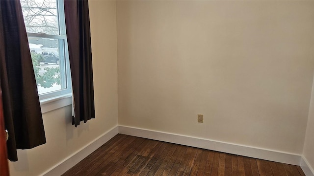 spare room with dark hardwood / wood-style flooring