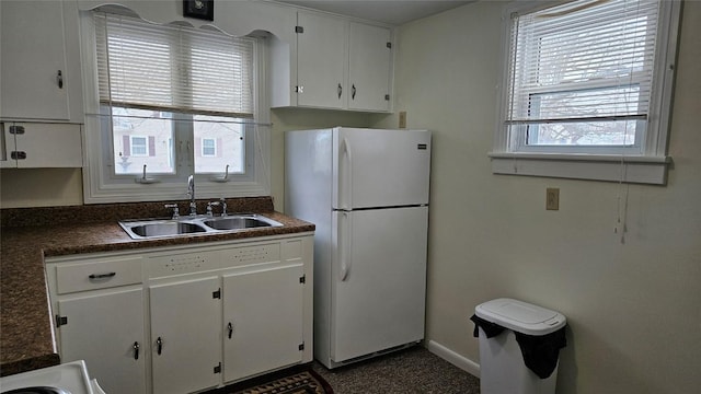 kitchen with sink, white cabinets, and white fridge