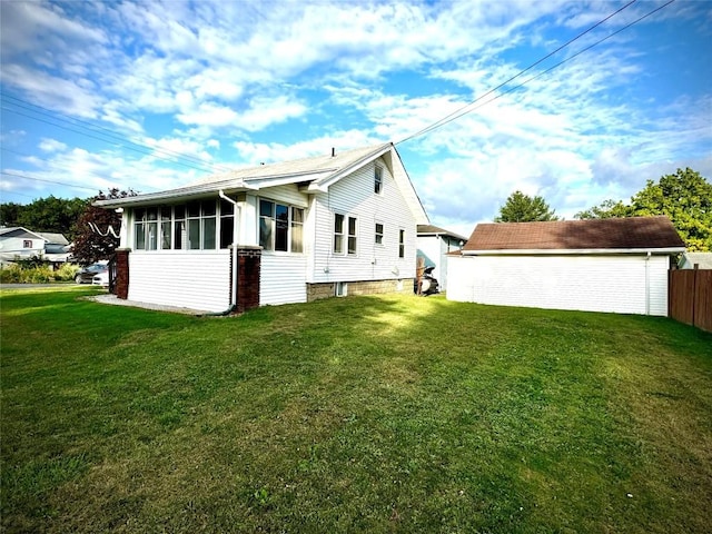 rear view of house with a yard