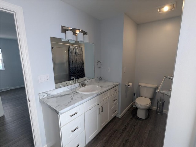 bathroom featuring vanity, a shower with curtain, wood-type flooring, and toilet