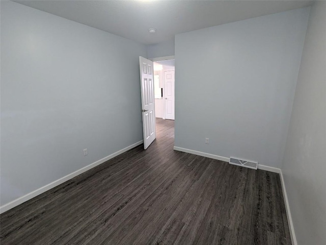 unfurnished room featuring dark wood-type flooring