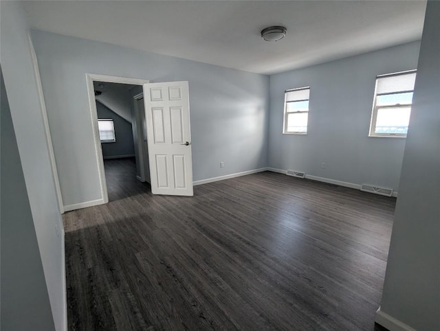 unfurnished room with dark hardwood / wood-style flooring