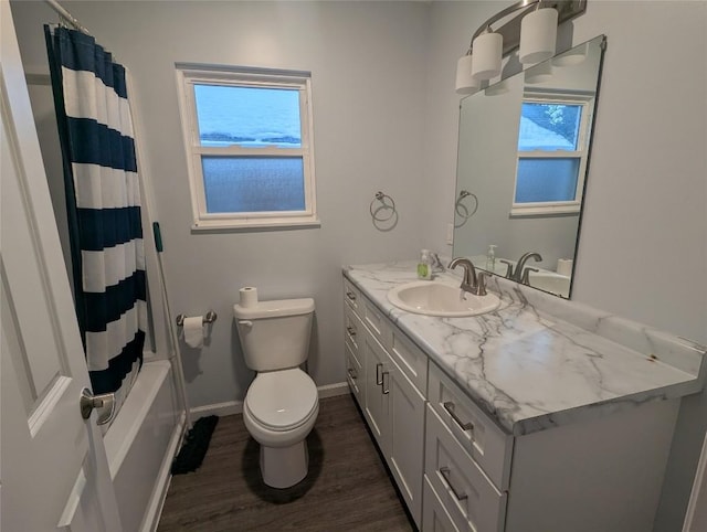 full bathroom featuring vanity, a healthy amount of sunlight, hardwood / wood-style floors, and toilet