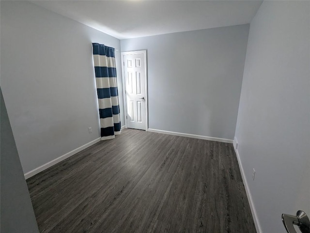 unfurnished room featuring dark hardwood / wood-style floors