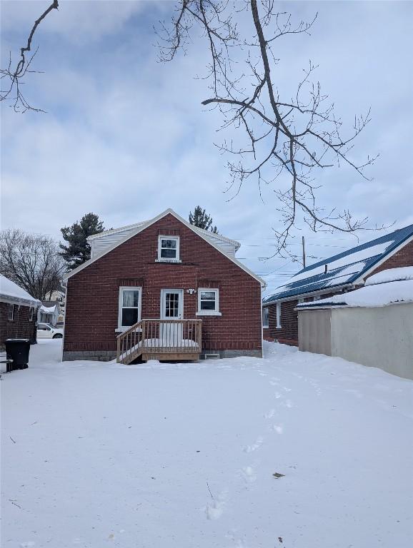 view of snow covered rear of property