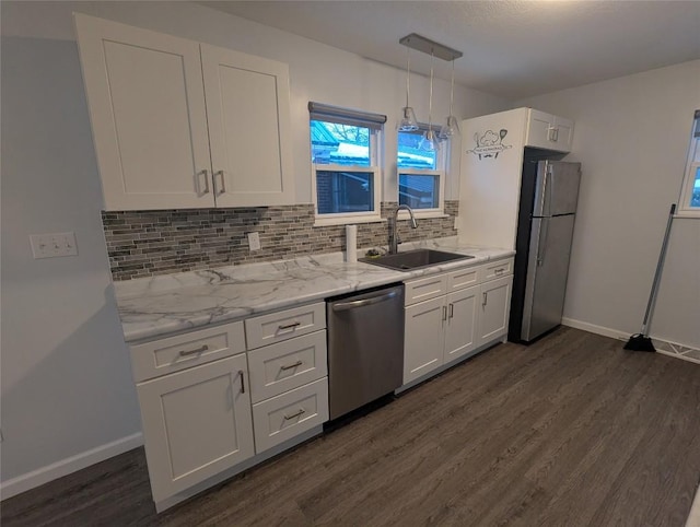 kitchen with sink, white cabinets, backsplash, hanging light fixtures, and stainless steel appliances