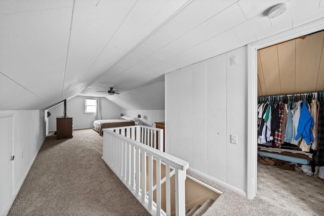 additional living space featuring carpet flooring and vaulted ceiling