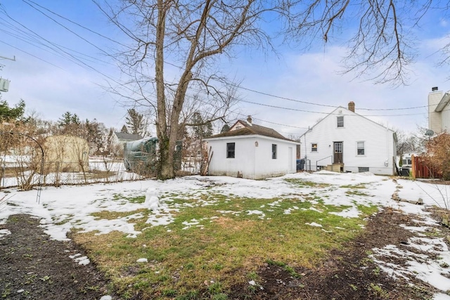 snow covered property with fence