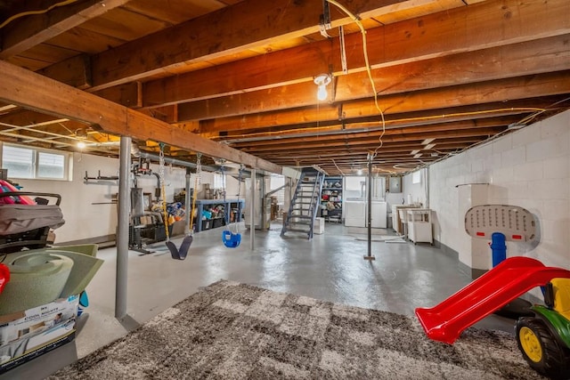 basement featuring stairs and washer and dryer