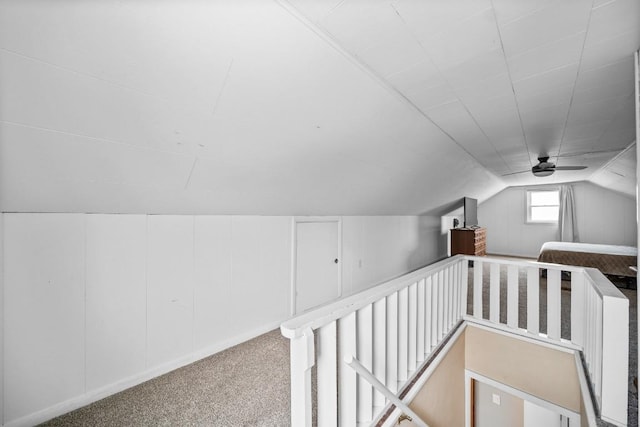 bonus room with vaulted ceiling and carpet floors