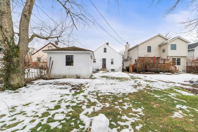 view of snow covered rear of property