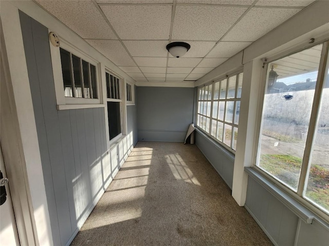 unfurnished sunroom featuring a paneled ceiling