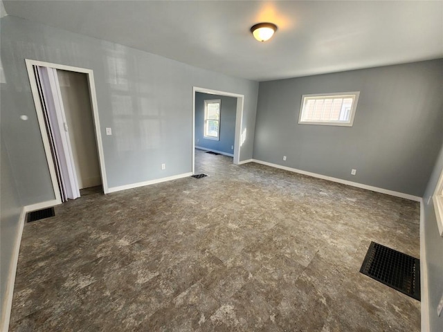 unfurnished room featuring plenty of natural light