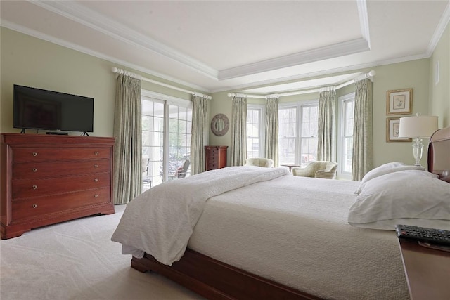 carpeted bedroom with access to outside, a tray ceiling, and crown molding