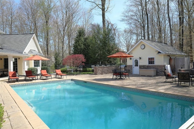 view of pool with a patio area and an outbuilding