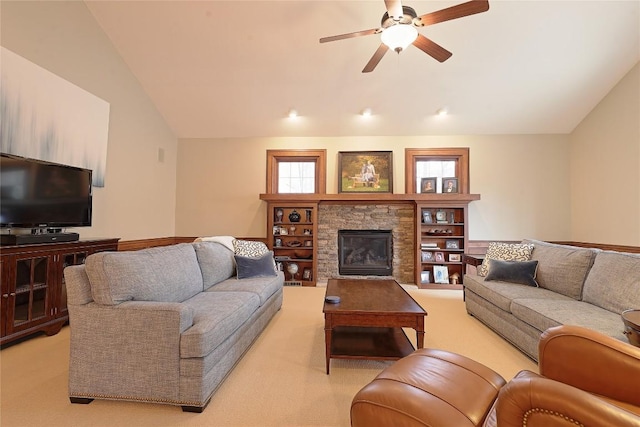 living room with ceiling fan, light colored carpet, lofted ceiling, and a fireplace