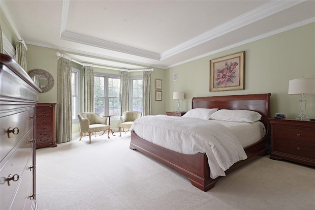 bedroom with light carpet, a raised ceiling, and ornamental molding