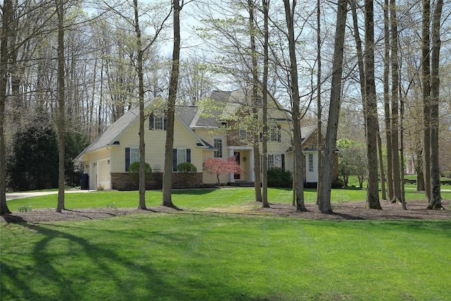 view of front of home with a front yard and a garage