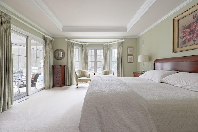 carpeted bedroom with a raised ceiling, access to exterior, and crown molding