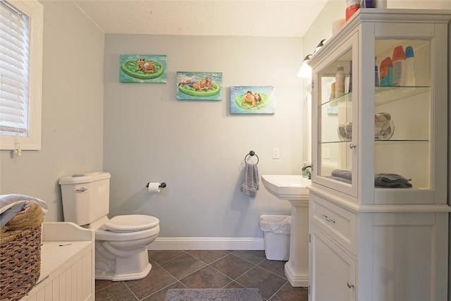 bathroom featuring tile patterned flooring and toilet