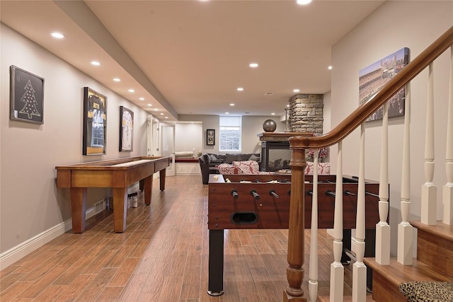 recreation room featuring a fireplace and hardwood / wood-style floors