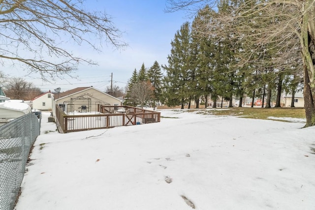 snowy yard featuring a deck