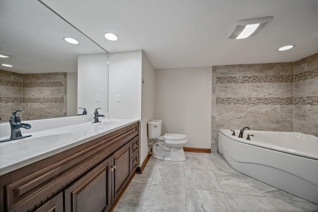 bathroom with vanity, toilet, a bathtub, and tile walls