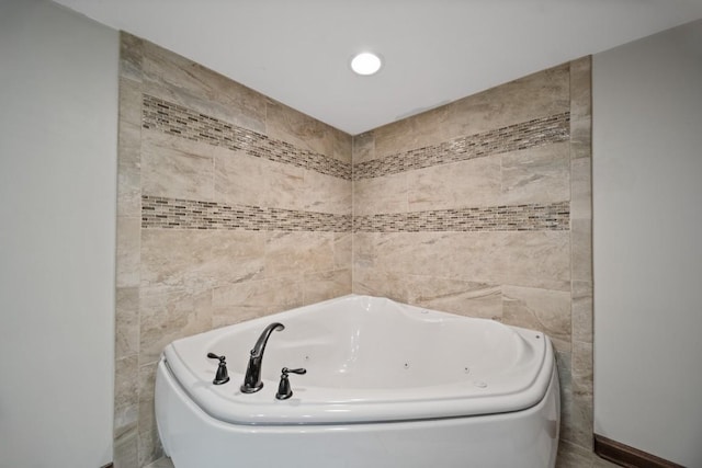 bathroom featuring tile walls and a bathtub