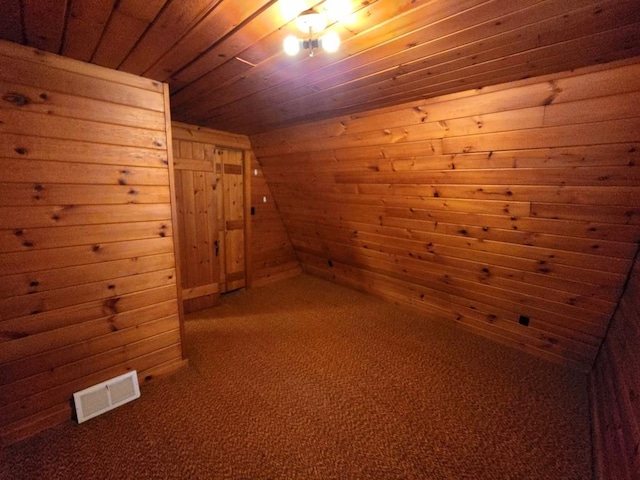 bonus room featuring carpet flooring, wooden ceiling, and wood walls