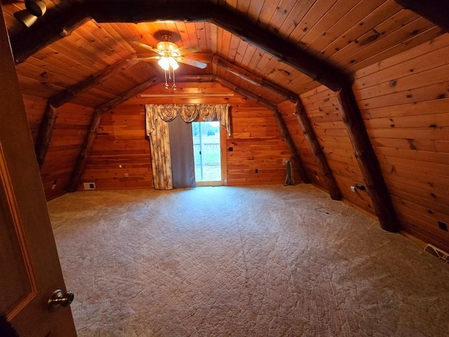 additional living space featuring lofted ceiling with beams, wood walls, and wood ceiling