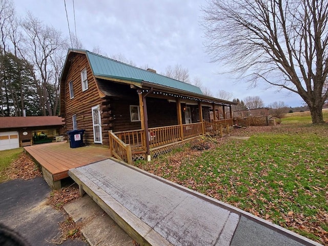 view of side of home with a porch and a yard